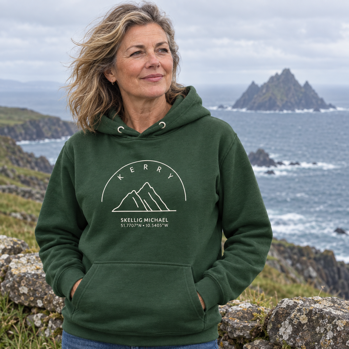 Woman wearing the Kerry Skellig Michael forest green hoodie on the Kerry coast